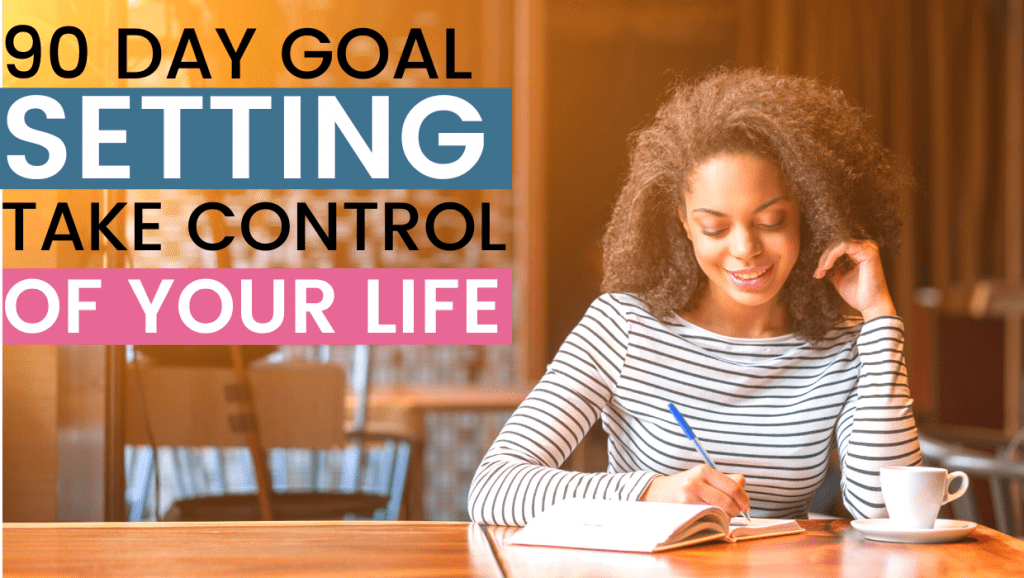 woman sitting at table writting in planner; 90 day goal setting